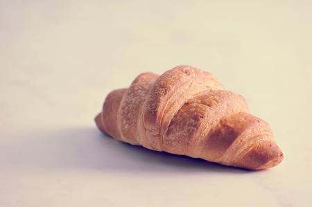 fresh croissant on white marble backgroundの写真素材