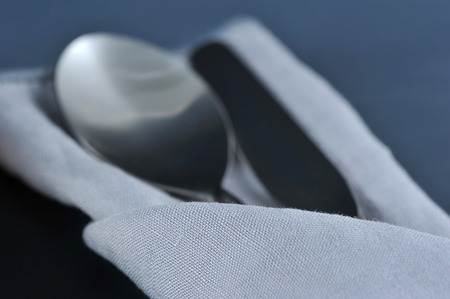 grey linen fabric and Cutlery selective focusの写真素材
