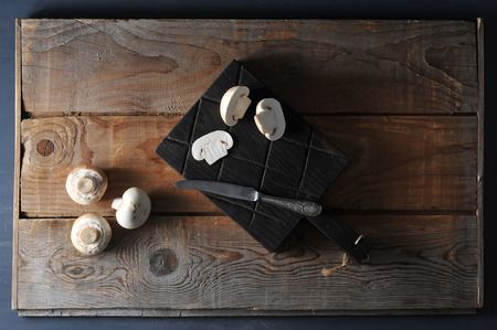 Fresh white mushrooms champignon on rustic wooden background. Top view. Copy space. Moodyの写真素材