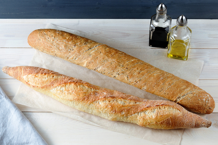 two baguette on Kraft paper on wooden rustic background の写真素材