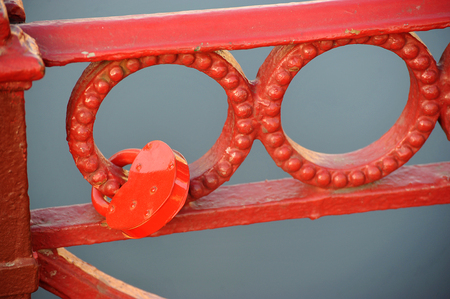 red lock on the grid of the red bridge - concept of loyalty, devotion and February 14の写真素材