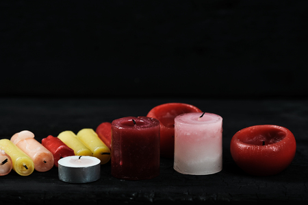 colorfull cinder from candles on a black wooden rustic background - place for textの写真素材