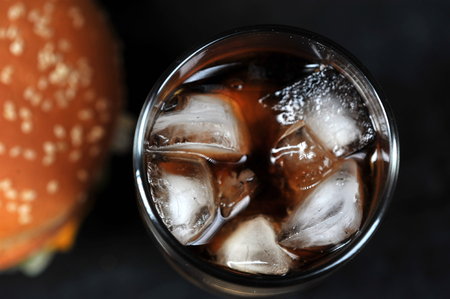 glass with ice on a black rustic background - top viewの写真素材