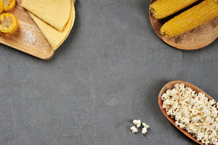 background from various kinds of corn, corn on the cob, corn bread, popcorn -  top view, copyspace