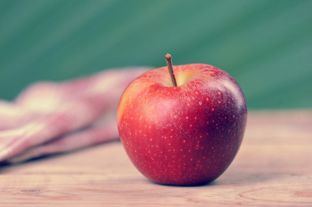 red juicy apple on wooden background close-upの写真素材