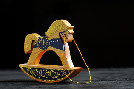 wooden toy horse on a dark backgroundの写真素材