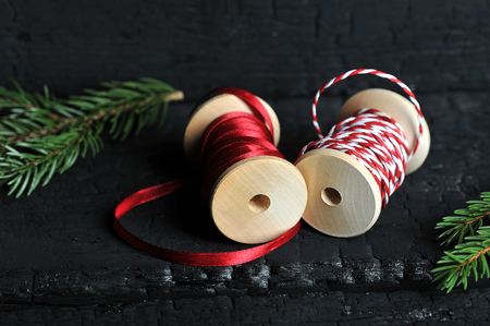 reels with red ribbons on dark background-Christmas background