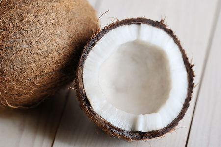 half-broken coconut on wooden background