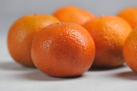 tangerines on a gray background-juicy ripe orange tangerinesの写真素材
