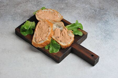 pate with bread and lettuce on a wooden Board - close up viewの写真素材