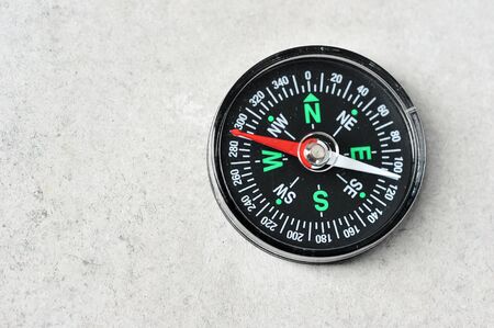 compass with a red magnetic arrow on a gray background with space for text - copy spaceの写真素材