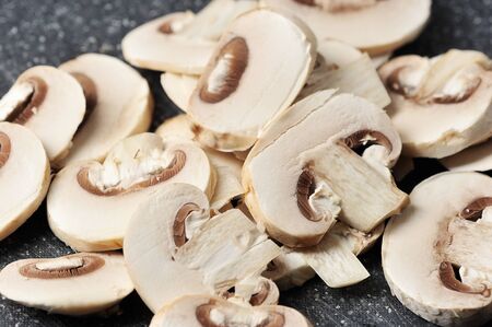 fresh mushrooms cut into pieces - mushrooms on a cutting Boardの写真素材