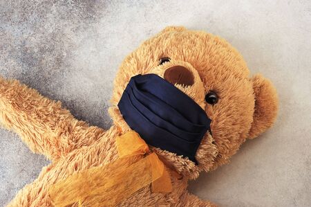 Teddy bear in a black protective mask -  concept of protection against coronavirus - stay at homeの写真素材