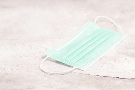 green protective mask on a grey concrete background