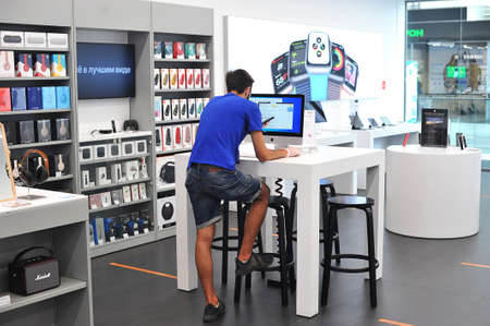 St. Petersburg, Russia - July 19, 2020: a man chooses goods in an apple store in St. Petersburg