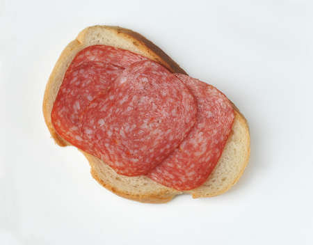 sandwich with white bread and salami isolated on a white background - top view