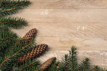 Christmas background with Christmas trees and cones on wooden background, top view, copy spaceの写真素材
