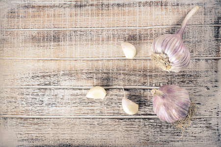 garlic heads on a dark stone - top view