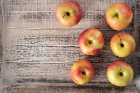 ripe red apples on a wooden background - top viewの写真素材