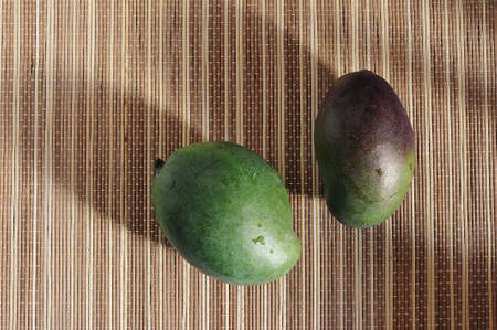 green mango on a reed lining - top view flat lay copyspaceの写真素材