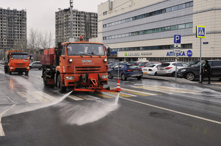 MOSCOW, RUSSIA - April 09, 2022: road services wash asphalt with detergent on the streets in Moscowのeditorial素材