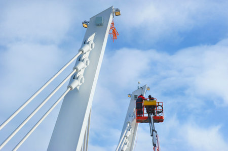 Moscow, Russia - February 21, 2025: workers work on a lift on the bridge over the Nagatinsky backwater in Moscowのeditorial素材