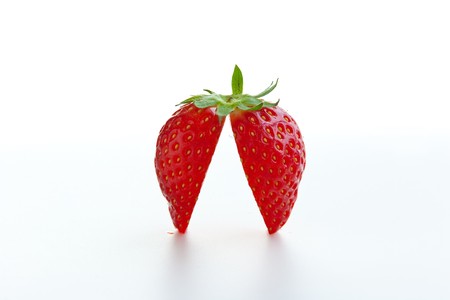 Fresh ripe strawberry cut into halves on white background. の写真素材