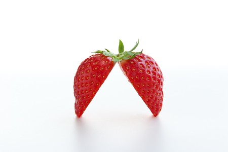 Fresh ripe strawberry cut into halves on white background. Clipping path includedの写真素材