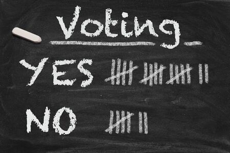 High resolution black chalkboard image with voting results on tally. Conceptual image for decision or democracy themes.の写真素材