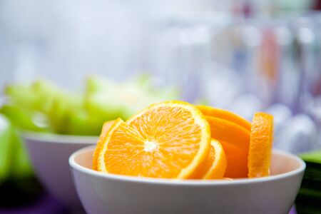 High resolution photography of some orange and carambola slices in bowls for cocktail decoration as party preperation. Shallow depth of field at orange. Copy space included. Portrait and landscape.の写真素材
