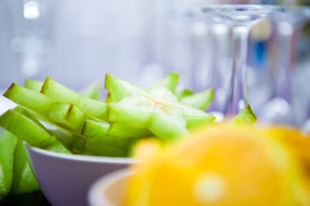 High resolution photography of some orange and carambola slices in bowls for cocktail decoration as party preparation. Shallow depth of field at carambola. Copy space included. Portrait and landscape.の写真素材