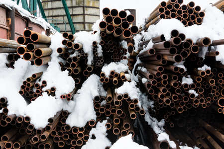 Metal rolling. A round tube of different sizes are available in the open air winter.の写真素材