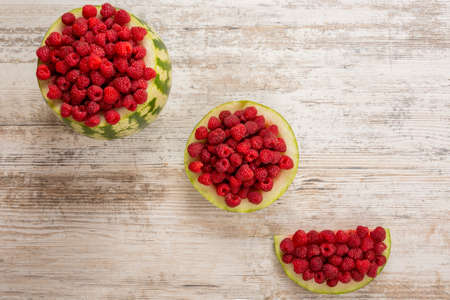 Watermelon, from the berries of ripe red raspberries. Half-length slice of watermelon with...