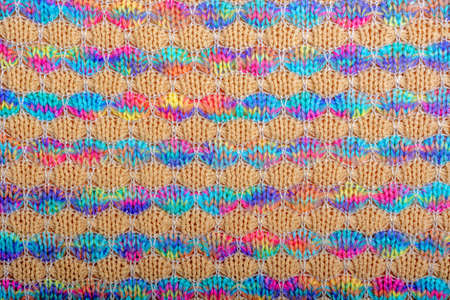 Abstract background. Colored knitted fabric texture, horizontal lines, flat lay