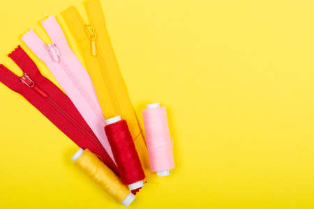 A set of tools and accessories for tailoring on a yellow background. Flat Lay, top view, Copy space,...