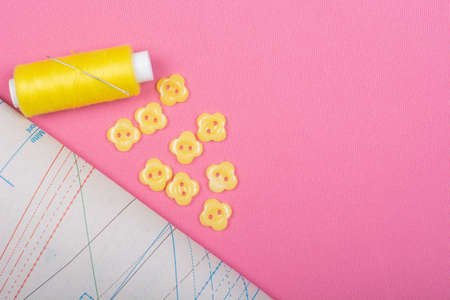 Spool of thread and yellow background. Needlework, sewing, embroidery. space for text, top view, flat lay, copy spaceの写真素材