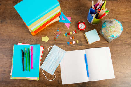 School at home during the quarantine period. Empty school notebook for text. Desk with school...