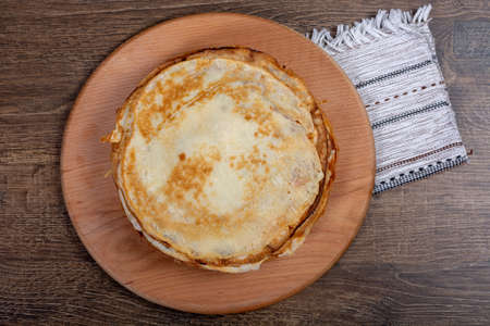 A stack of pancakes lies on a round board. Close-up, top view, Flat Lay, Copy space, place for text....