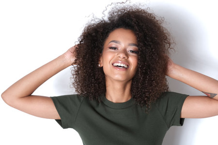 Happy brunette with curly hair.