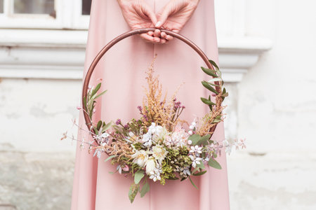Beautiful bouquet in the hands of a girl in a pink dressの写真素材