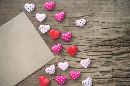 blank gift card and red  hearts on wooden background