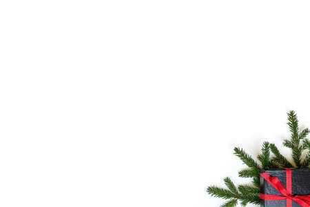 Fir branch / twig and black christmas gift box on white background. Christmas border with empty blank copy space for text.の写真素材
