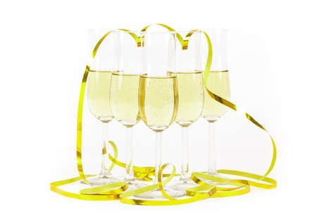 Glasses of champagne lined up and party streamers. For new years eve celebration and special moments.の写真素材