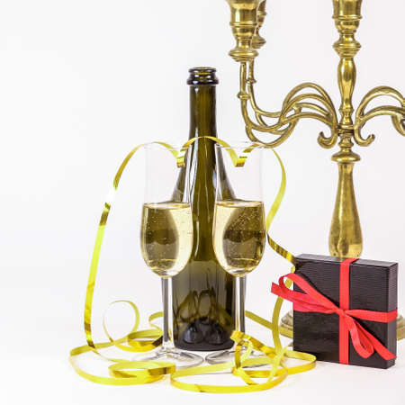 Glasses of champagne, gift box and party streamers. For new years eve celebration, valentine's day and special moments.の写真素材