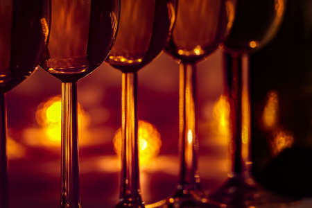 Cozy evening with glasses of champagne. For celebrations and special moments. Warm decoration light in background.の写真素材