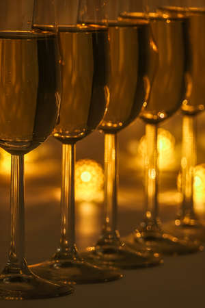 Cozy evening with glasses of champagne. For celebrations and special moments. Warm decoration light in background.の写真素材