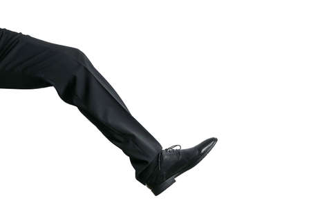 Legs and shoes from a well dressed businessman in a black suit. Isolated on white background with...