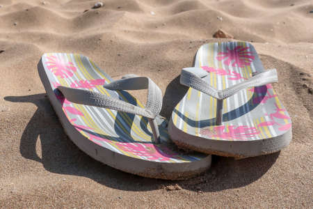 Colorful flip flop sandals on the sandy beach in Crete, Greece.の写真素材