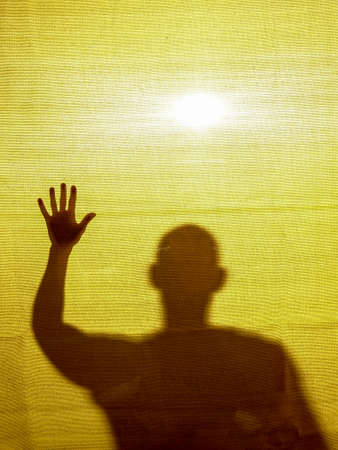 Abstract / surreal image of a man trapped behind a fabric.の写真素材