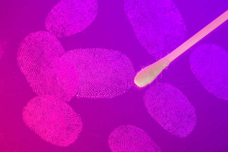 Crime scene. Cotton swab collects evidence and DNA. Fingerprints on glass with red and blue background that look like police sirens.の写真素材